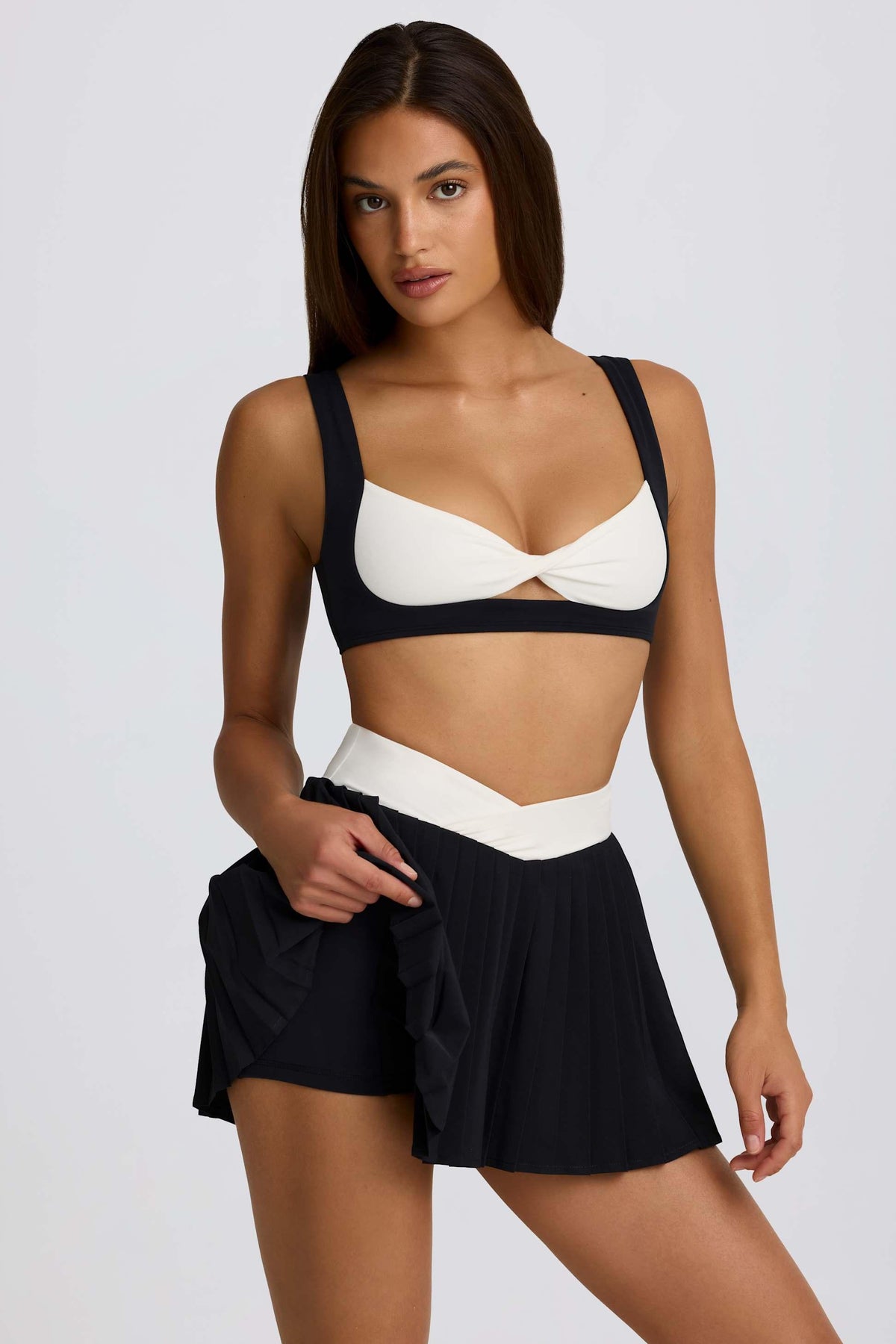 Soft Active Crossover Pleated Mini Skort In Black