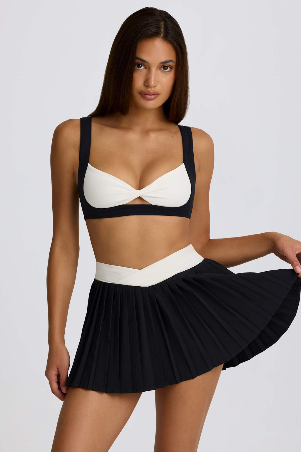 Soft Active Crossover Pleated Mini Skort In Black